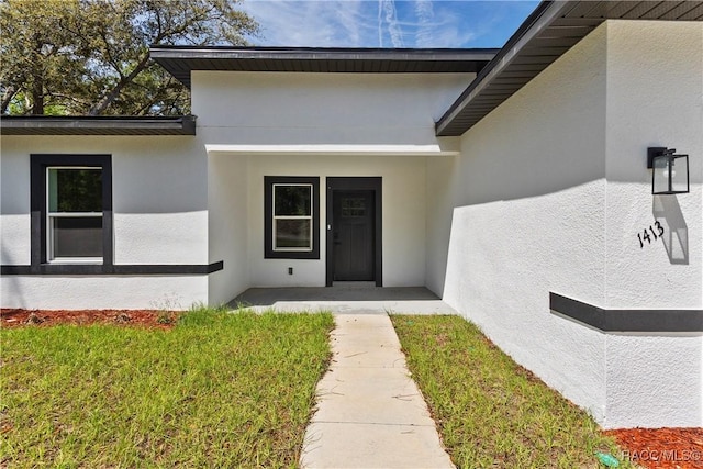 1413 W America Pl, Citrus Springs, FL 34434 - doorway to property featuring stucco siding