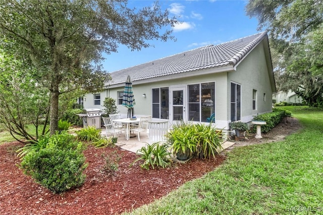 rear view of property featuring a patio area