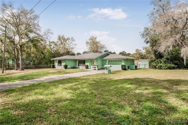 single story home featuring driveway, a front yard, and fence