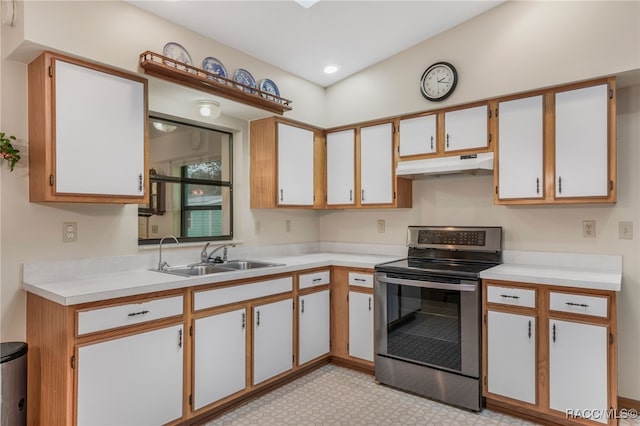 kitchen with light countertops, electric stove, under cabinet range hood, and a sink