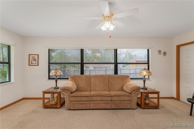 living room with baseboards, carpet, and ceiling fan