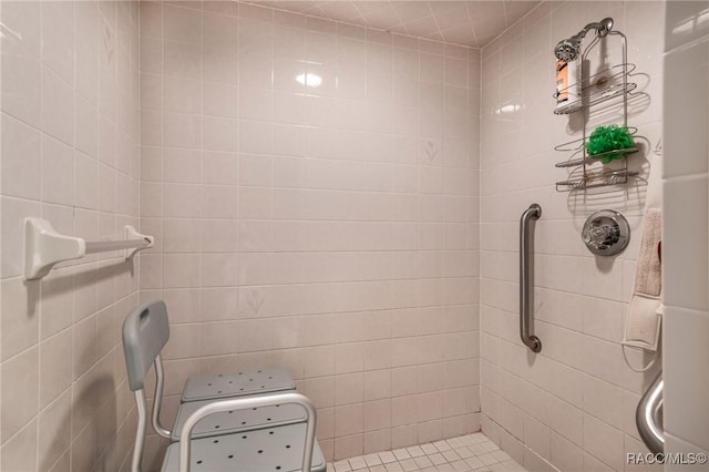 full bath featuring tile walls and tiled shower