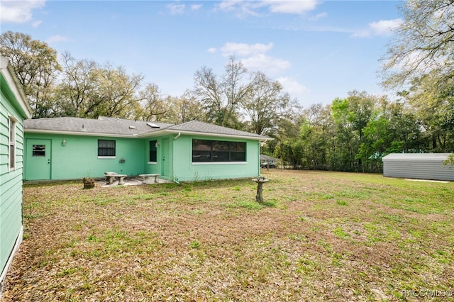 back of property with a lawn