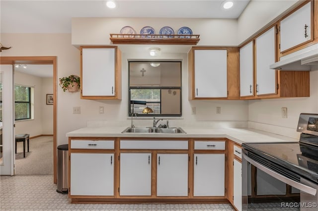 kitchen with recessed lighting, a sink, light countertops, stainless steel range with electric stovetop, and under cabinet range hood