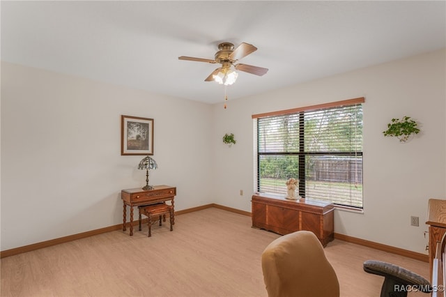 home office featuring a ceiling fan, light wood-type flooring, and baseboards