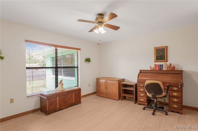 office space with a ceiling fan, baseboards, and light wood-type flooring