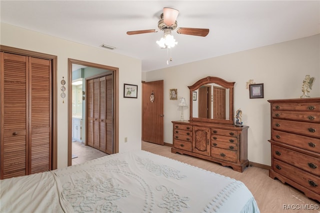 bedroom featuring light wood-type flooring, visible vents, baseboards, and a ceiling fan