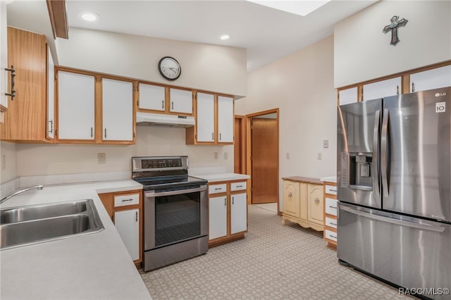 kitchen featuring under cabinet range hood, light countertops, recessed lighting, appliances with stainless steel finishes, and a sink