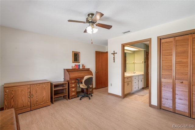 office featuring visible vents, ceiling fan, baseboards, and light wood-style floors