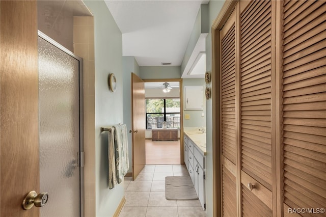 full bathroom featuring tile patterned flooring, visible vents, a stall shower, a closet, and vanity