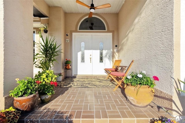 entrance to property featuring ceiling fan