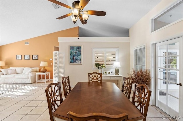 dining area with light tile patterned flooring, ceiling fan, and vaulted ceiling