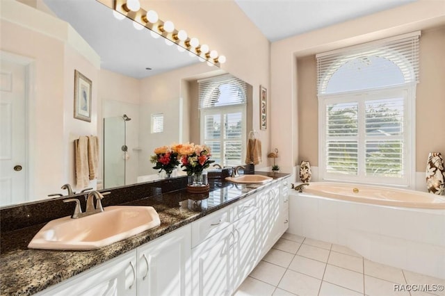 bathroom with tile patterned flooring, vanity, a wealth of natural light, and shower with separate bathtub