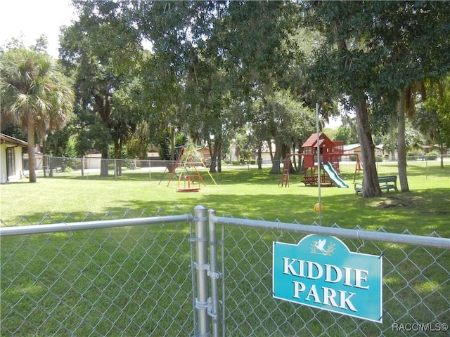 view of property's community with a playground and a yard