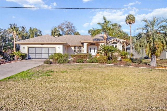 view of front of house featuring a garage and a front yard