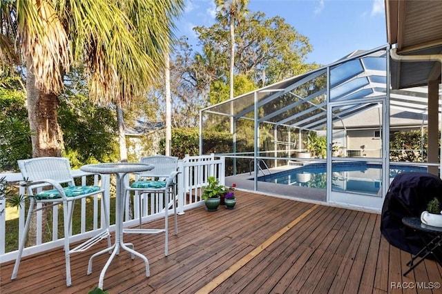 wooden deck featuring a lanai and grilling area