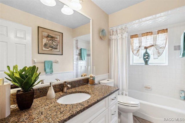 full bathroom with shower / bathtub combination with curtain, tile patterned floors, vanity, and toilet