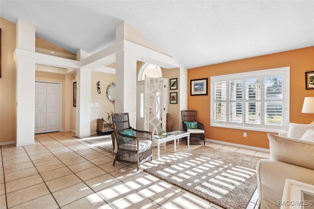 living room with light tile patterned floors and vaulted ceiling