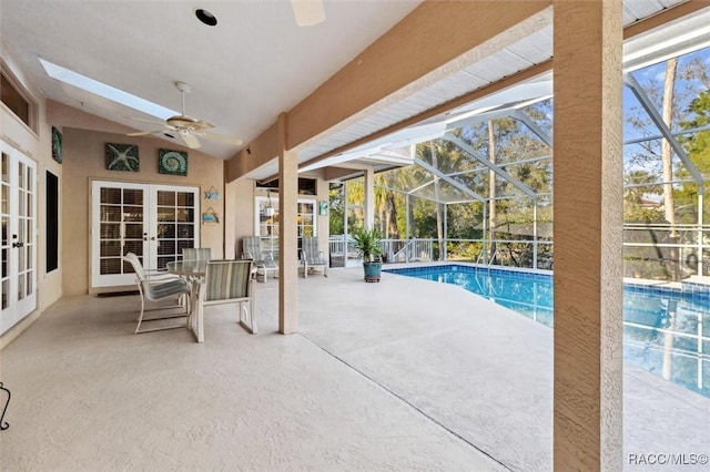 view of pool with french doors, ceiling fan, a patio, and glass enclosure