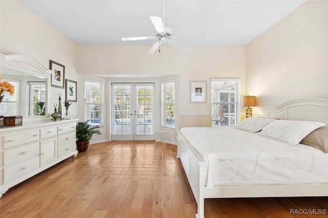 bedroom featuring ceiling fan, access to outside, light wood-type flooring, and french doors