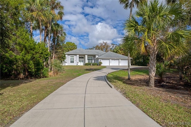 view of front of home with a garage and a front lawn