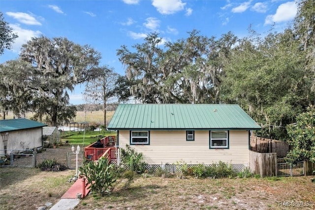 view of side of home featuring a wooden deck