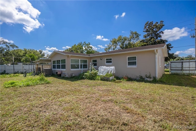 back of property with a lawn