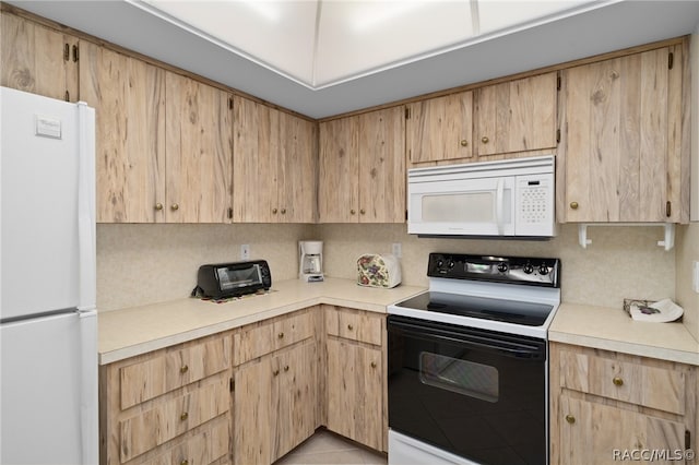 kitchen with light brown cabinets and white appliances