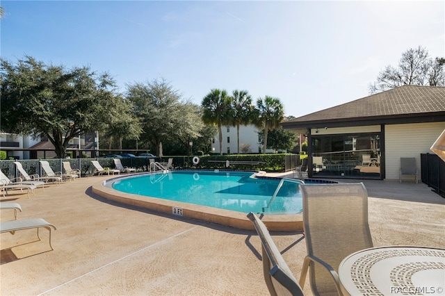 view of swimming pool featuring a patio area