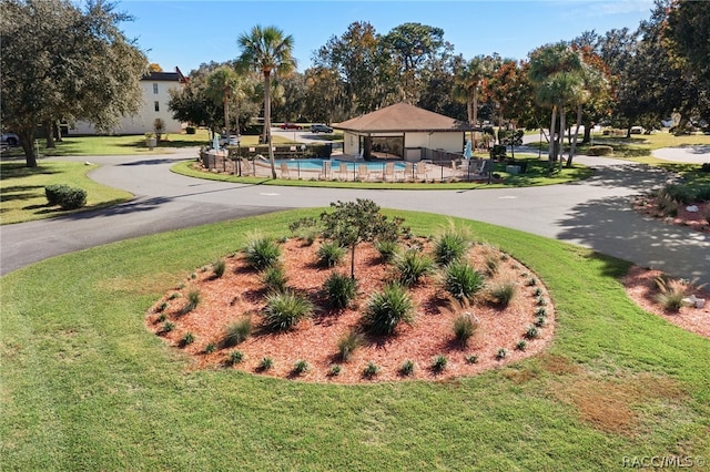 view of community with a swimming pool and a yard