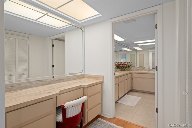 bathroom with tile patterned floors and vanity