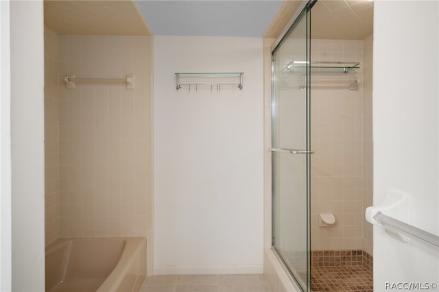 bathroom featuring tile patterned flooring and independent shower and bath