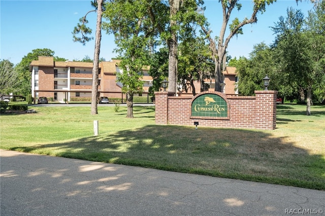 view of home's community with a yard