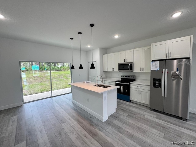 7549 N Santos Dr, Citrus Springs, FL 34434 - kitchen with appliances with stainless steel finishes, baseboards, a sink, light wood-style flooring, and white cabinets