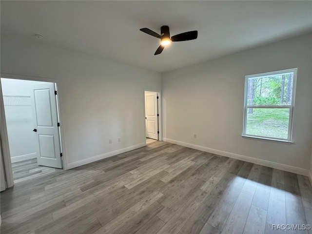 7549 N Santos Dr, Citrus Springs, FL 34434 - empty room featuring ceiling fan, wood finished floors, baseboards, and a smoke detector