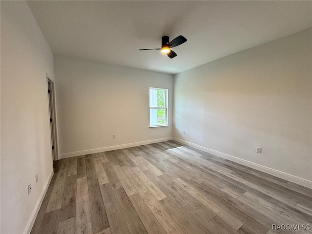 7549 N Santos Dr, Citrus Springs, FL 34434 - empty room with a ceiling fan, wood finished floors, and baseboards