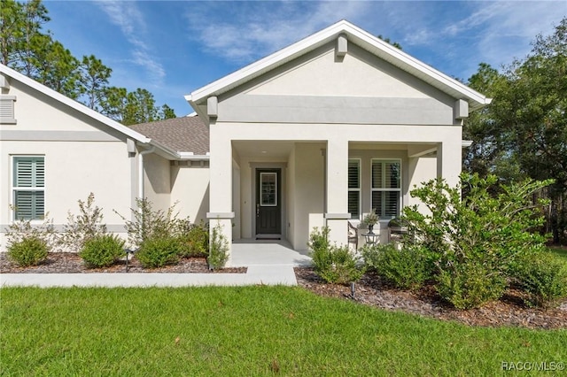 view of front of property with a front yard and a porch