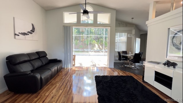 living room with wood-type flooring, ceiling fan, and lofted ceiling