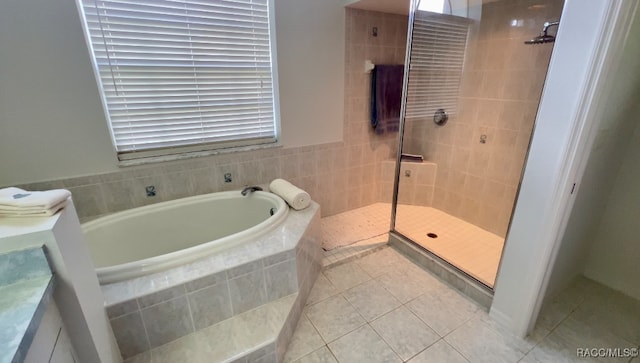 bathroom with tile patterned floors and separate shower and tub