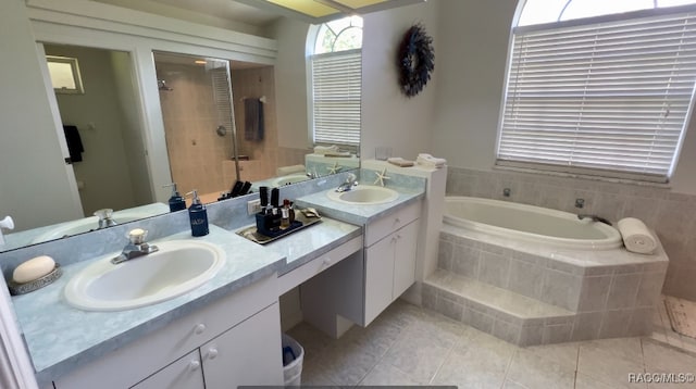 bathroom with tile patterned floors, vanity, and independent shower and bath