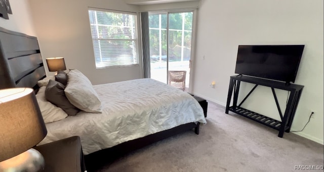 carpeted bedroom with access to outside