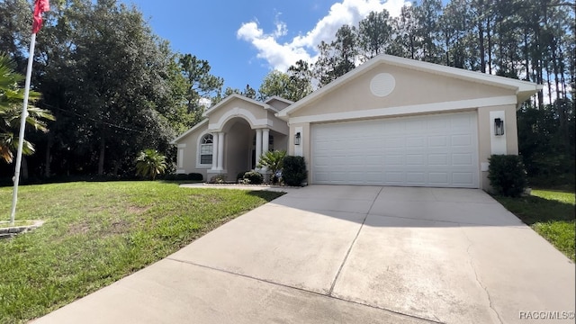 single story home with a front yard and a garage