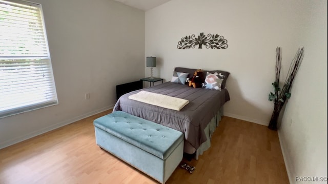 bedroom with hardwood / wood-style flooring