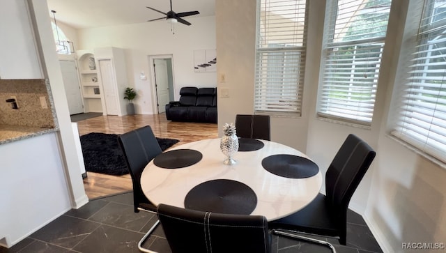 dining room with ceiling fan and dark hardwood / wood-style flooring