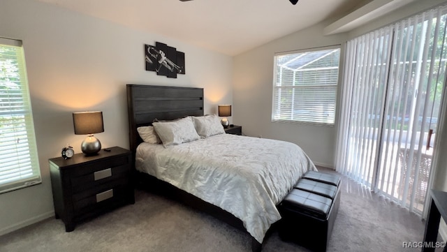 carpeted bedroom featuring multiple windows and lofted ceiling