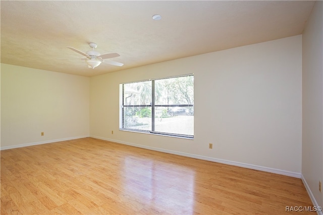 spare room featuring ceiling fan and light wood-type flooring