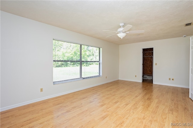 spare room featuring ceiling fan and light hardwood / wood-style floors