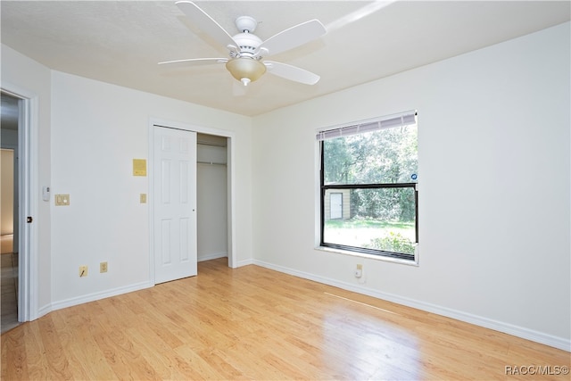 unfurnished bedroom with a closet, light hardwood / wood-style flooring, and ceiling fan