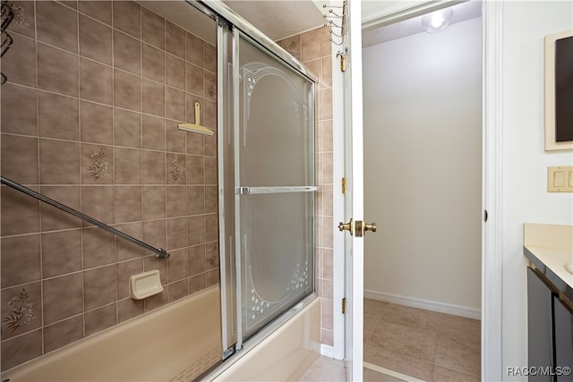 bathroom featuring tile patterned floors, vanity, and enclosed tub / shower combo