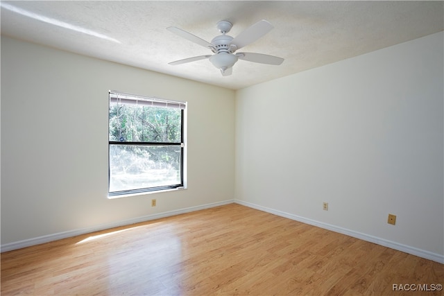 spare room featuring ceiling fan, a textured ceiling, and light wood-type flooring